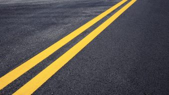 Traffic line of yellow on street with texture background.